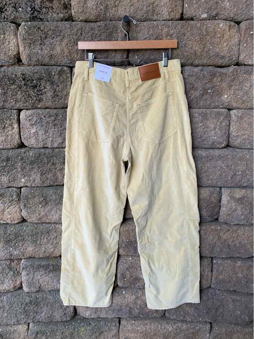 Tan mid-rise straight-leg pants with five-pocket design and leather brand patch on waistband.