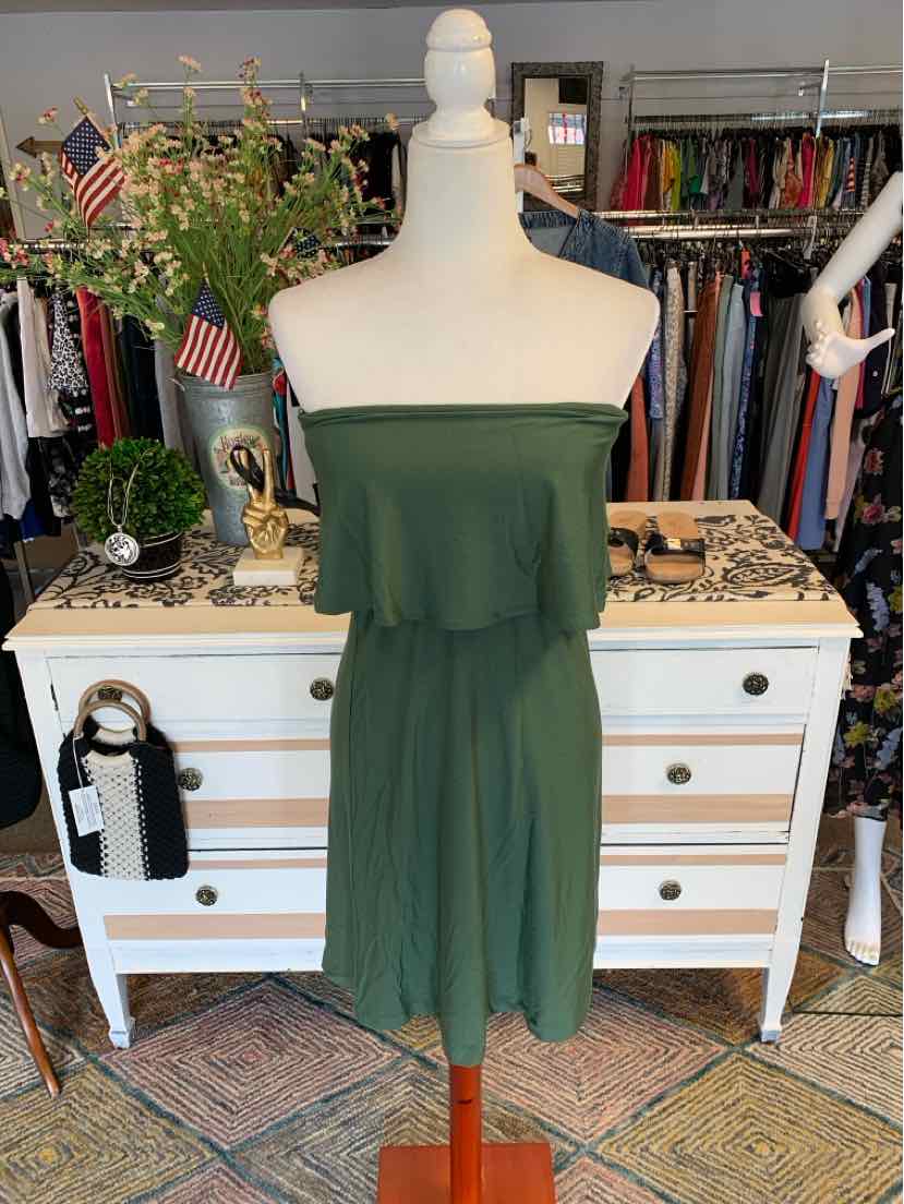 Strapless olive green knee-length dress with ruffled bodice on mannequin.