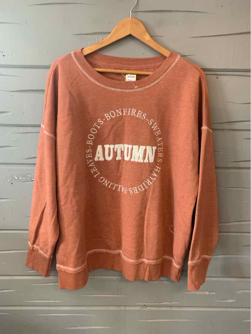 Rust-colored crewneck sweatshirt with white "AUTUMN" text and casual fit.