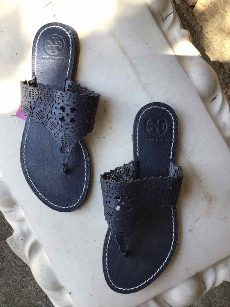 Black leather Tory Burch sandals with cut-out floral design and thong strap, size 6.