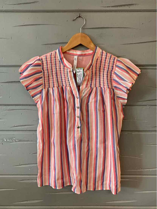 Pink and white striped short-sleeve blouse with puff sleeves and smocked yoke on wooden hanger.
