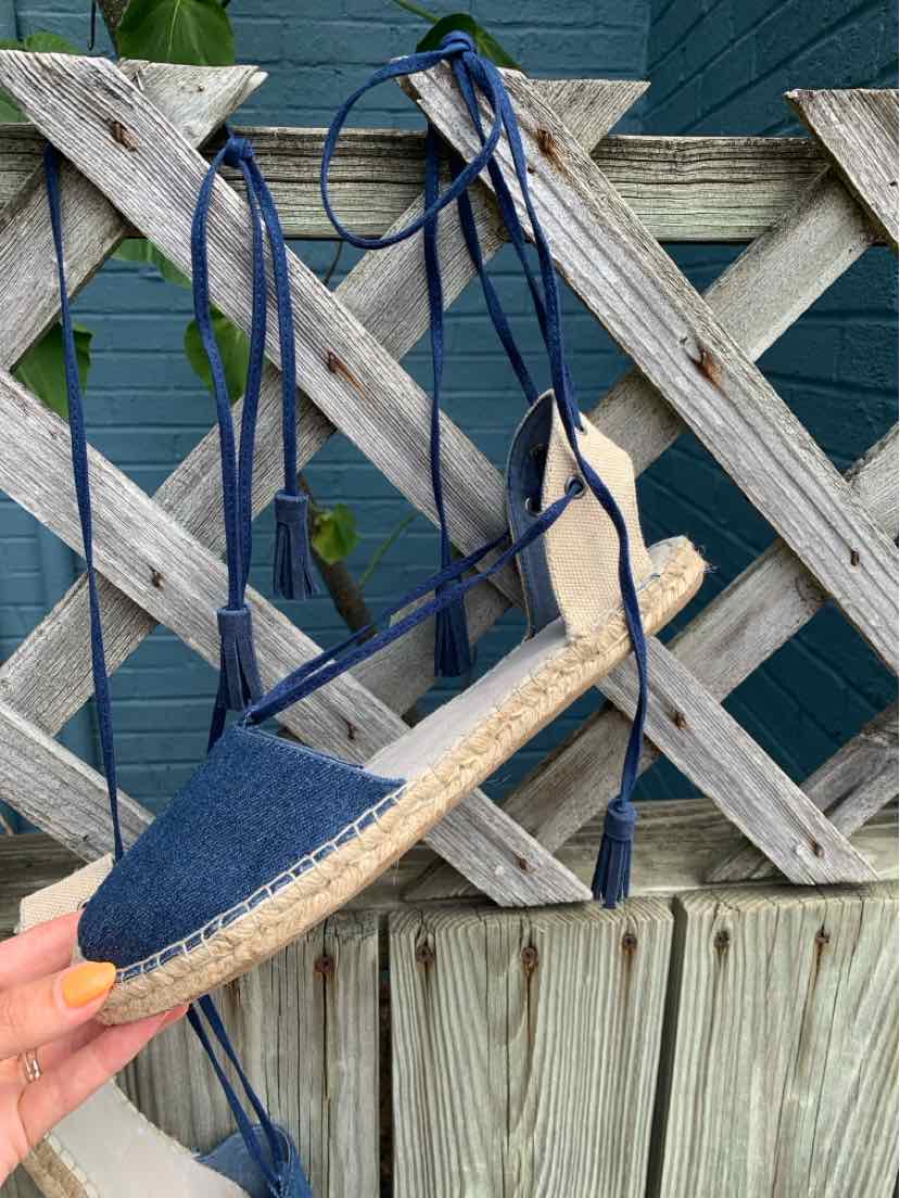 Navy blue espadrille flat with ankle wrap laces and woven jute sole.