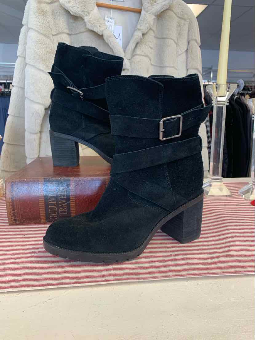 Black suede ankle boots with block heels and decorative side buckle straps.