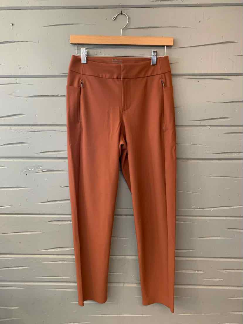 Rust-colored Athleta women’s leggings with a wide waistband and slim, full-length legs.