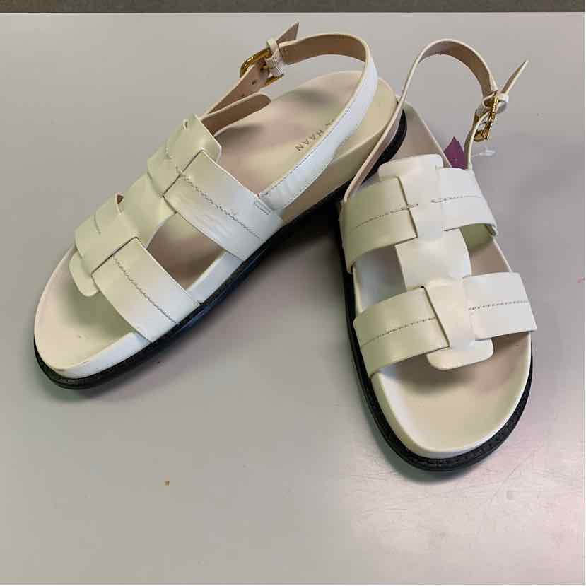 White leather women's sandals with woven strap design, adjustable ankle buckle, and black sole.