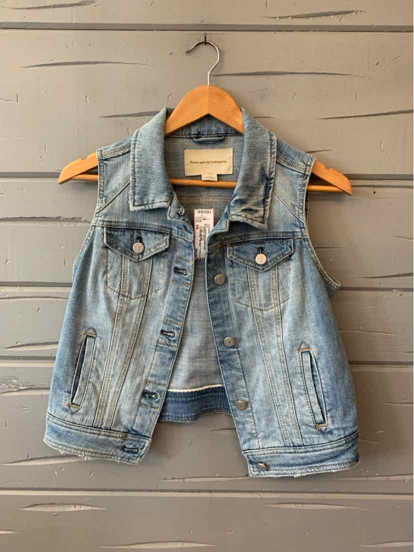 Light blue sleeveless denim vest with front button closure and two chest pockets on wooden hanger.