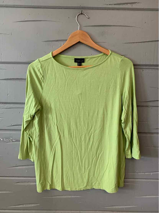 Light green long-sleeve knit top with scoop neckline and slim fit on wooden hanger.