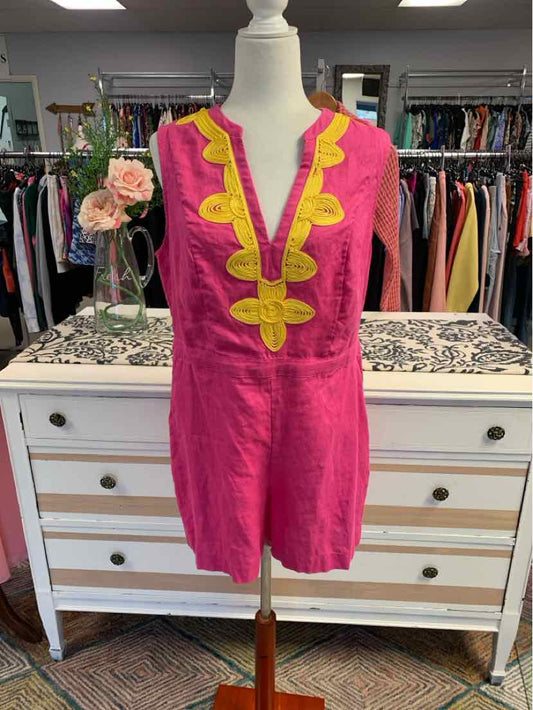 Pink sleeveless tunic with yellow embroidered neckline on white mannequin.