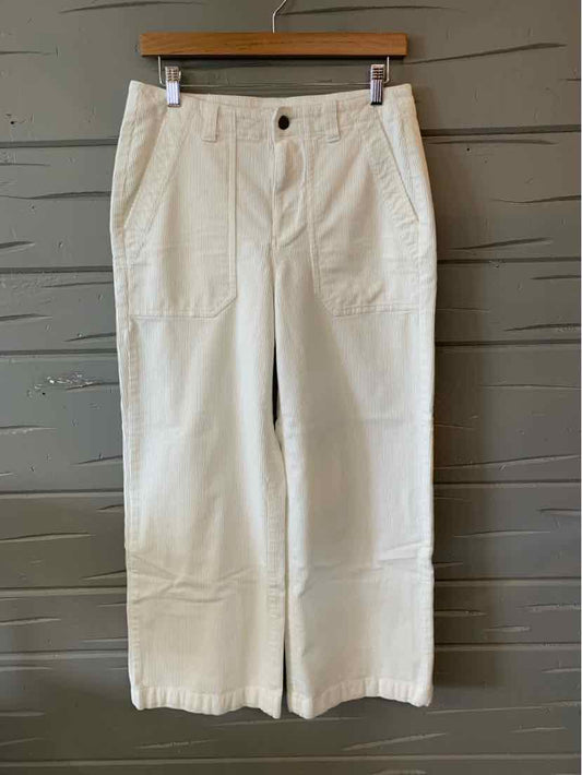 White wide-leg pants with front patch pockets and button closure, size 8.