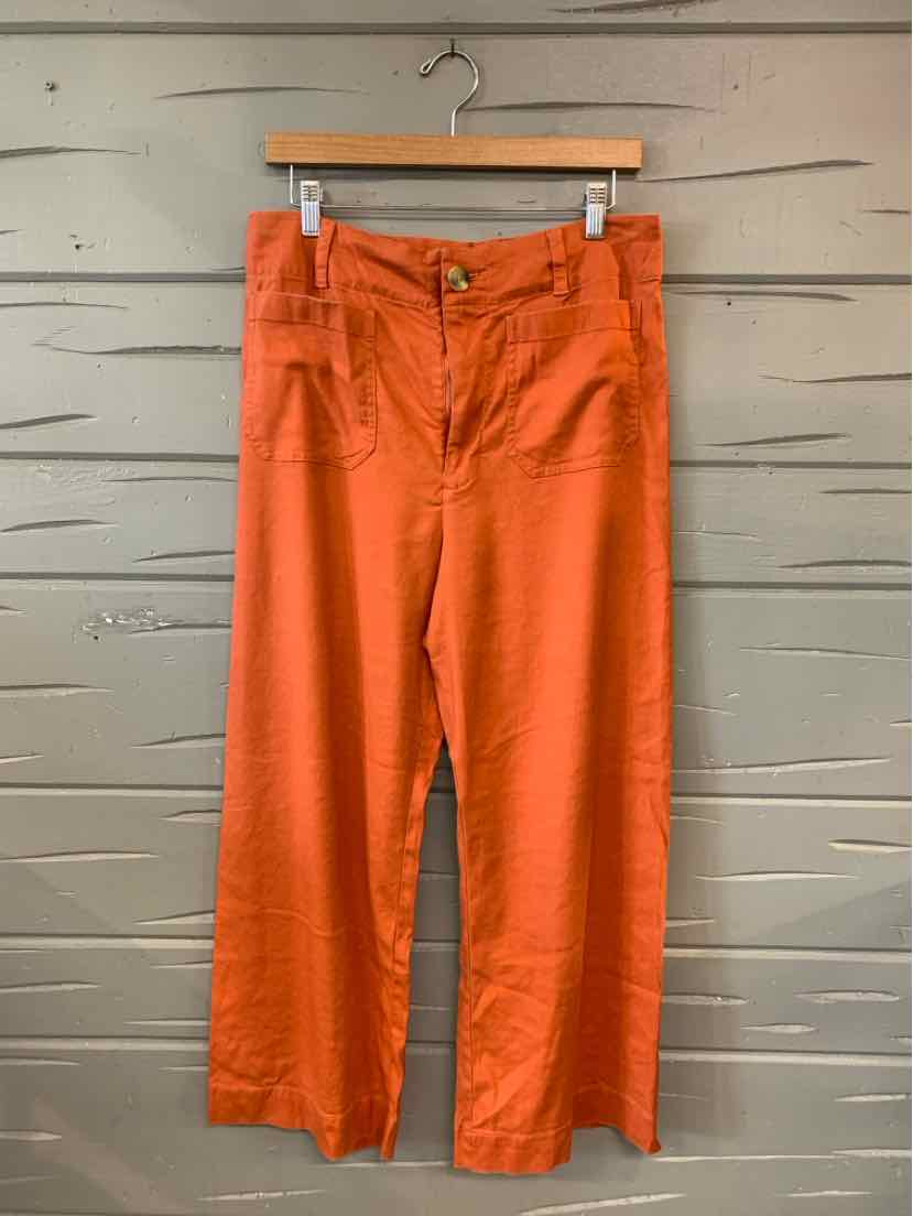 Rust-orange solid wide-leg pants with a high waist and front button closure.
