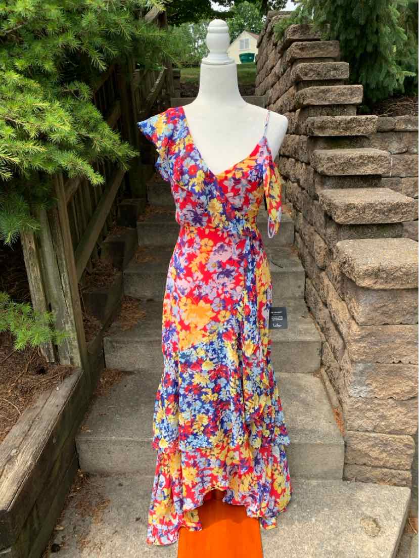 Sleeveless floral midi dress with V-neck, ruffle details, and vibrant multicolor print.