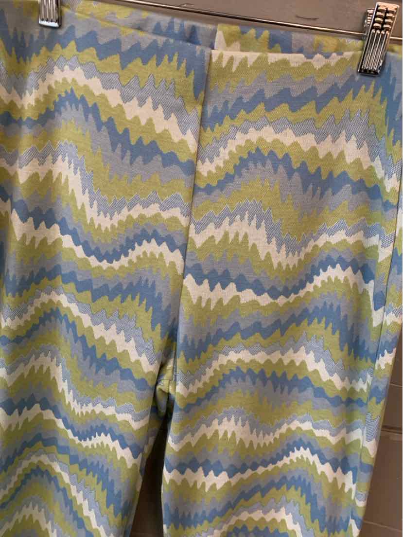 High-waisted pants with a wavy zigzag pattern in green, blue, beige, and white tones, made of lightweight fabric.