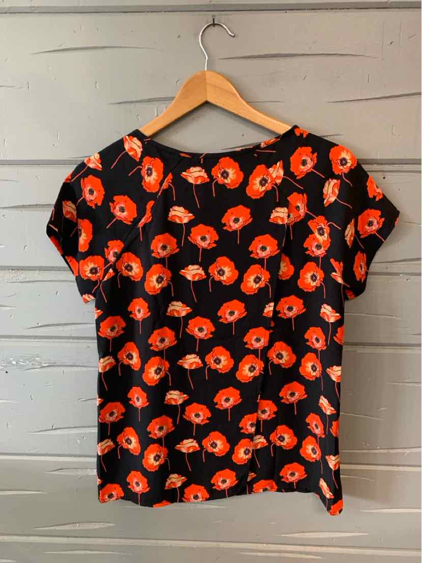 Black short-sleeve blouse with bright orange floral print, size XS.
