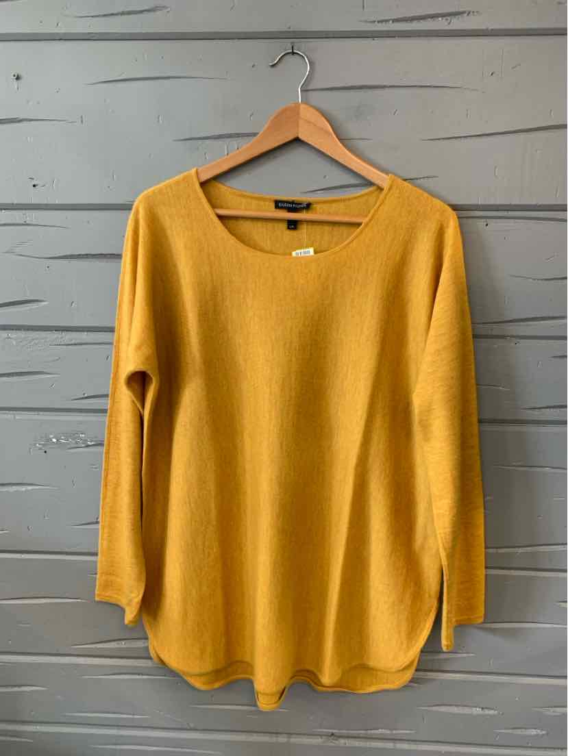 Mustard yellow long-sleeve cashmere sweater with scoop neck and relaxed fit on wooden hanger.