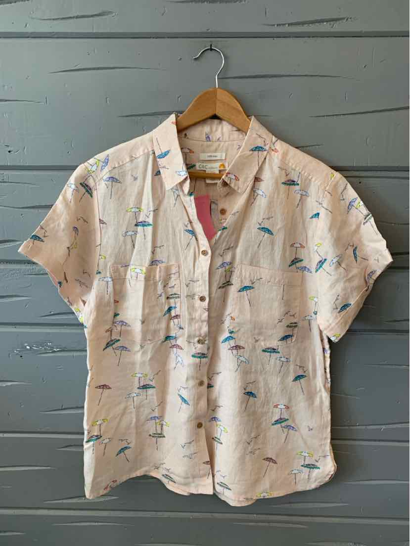 Light beige short-sleeve button-up shirt with colorful beach-themed prints on wooden hanger.
