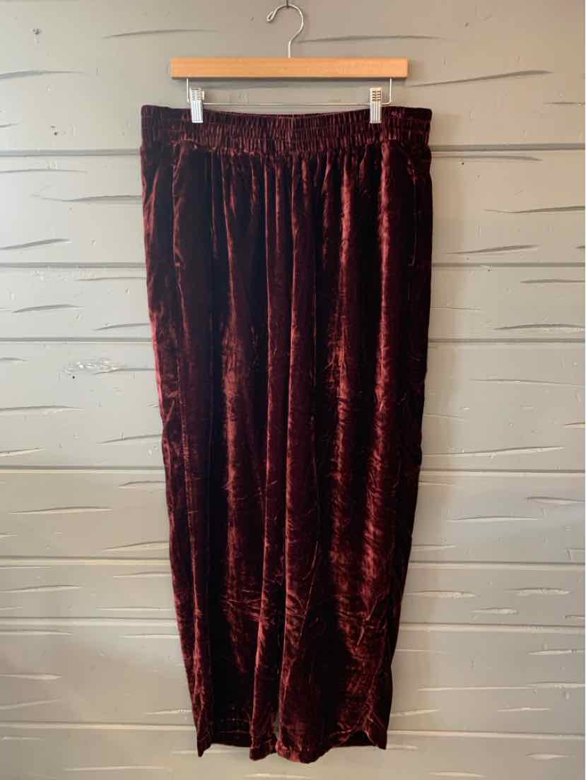 Burgundy velvet wide-leg pants with elastic waistband, size 18, hanging on wooden hanger.