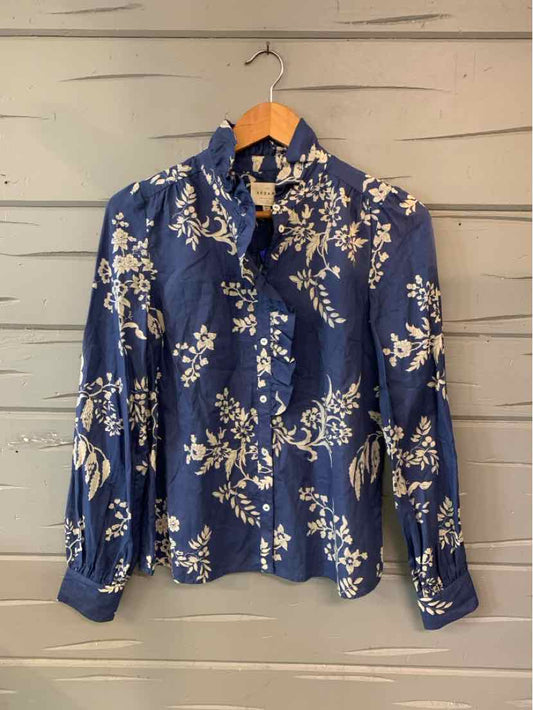 Navy blue button-up blouse with a pointed collar, long sleeves, and cream floral print.