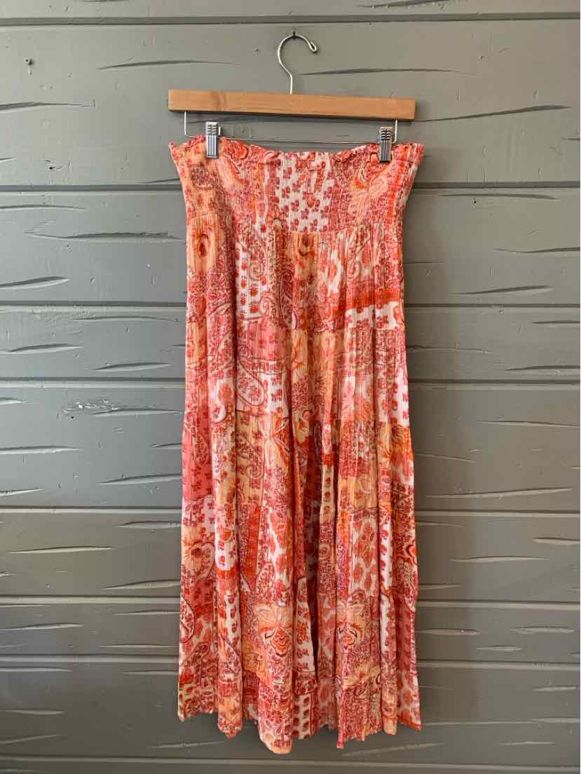 Long pleated skirt in pink-orange floral pattern with elastic waistband, size medium.