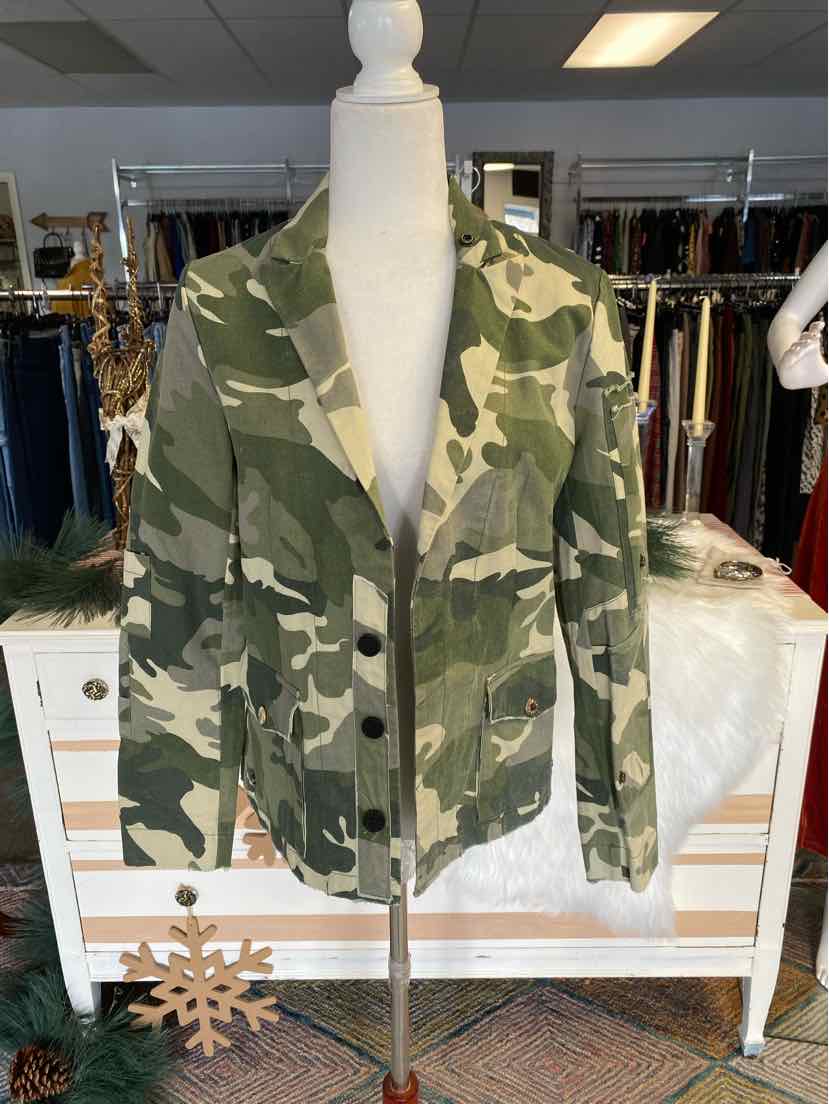 Green and beige camo blazer with notch lapels and front pockets on a mannequin.