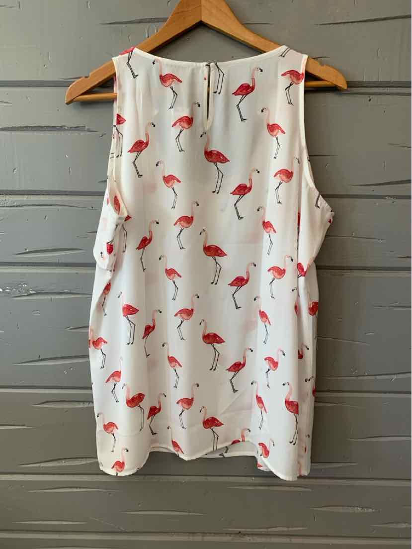 White sleeveless blouse with pink flamingo print and round neckline, size large, hanging on wooden hanger.