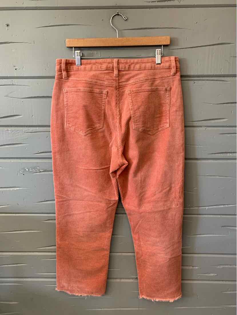 Salmon-pink corduroy pants with a straight-leg fit, belt loops, and back patch pockets.