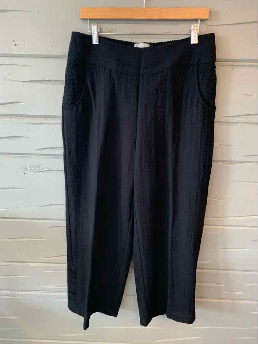Black high-waisted pants with wide legs and side pockets, made from solid fabric.
