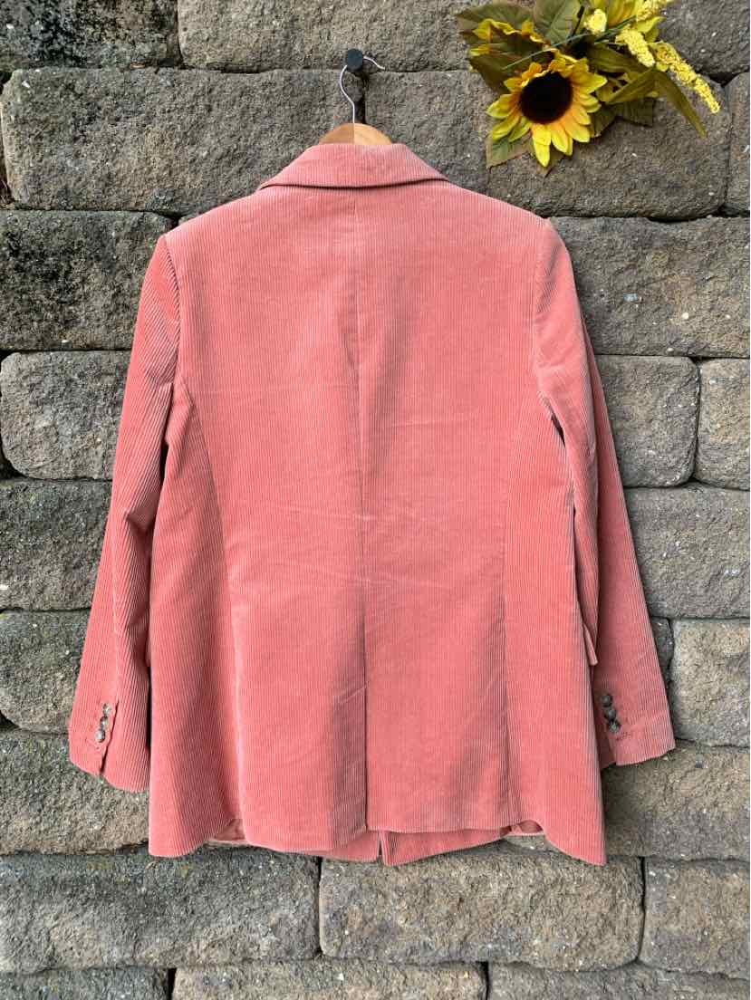 Pink corduroy blazer with notched collar, long sleeves, and back vent detailing.