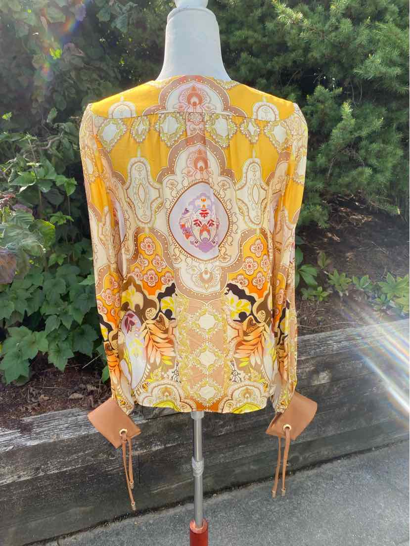 Long-sleeve lightweight blouse with yellow and orange paisley pattern on sheer fabric.