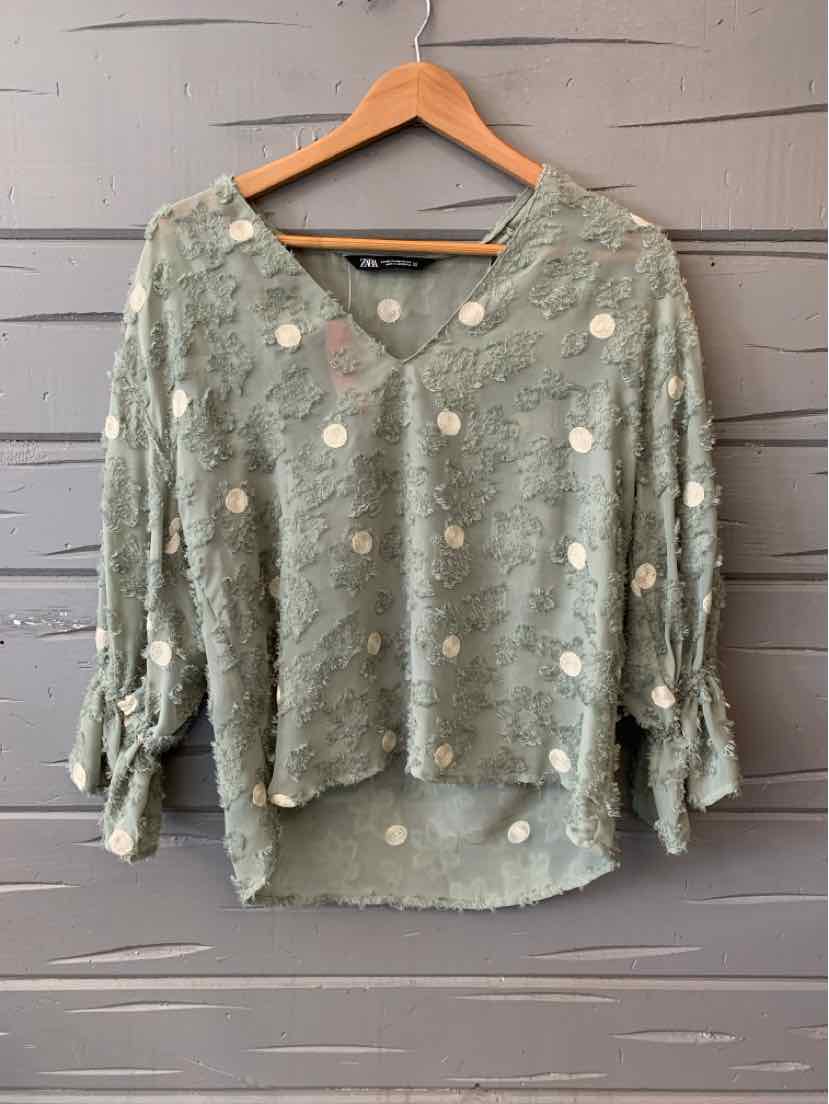 Light green textured blouse with white floral dots, V-neck, and tie sleeves, size XS.