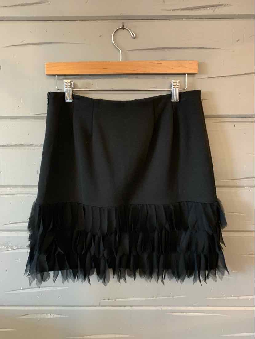 Black mini skirt with layered feather trim hem and straight fit, size 4P.