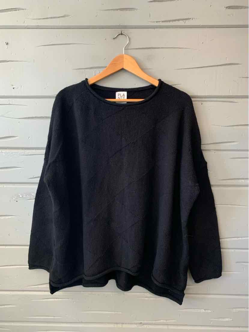 Black oversized knit pullover with a round neckline, long sleeves, and a relaxed hem.