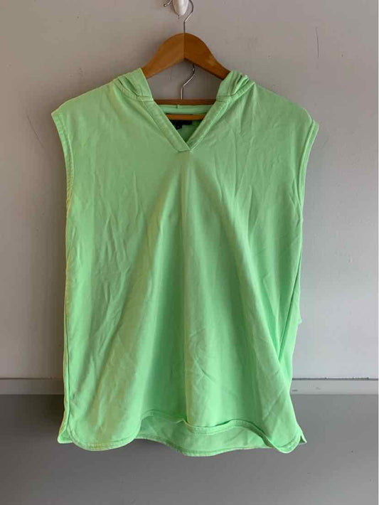 Light green sleeveless hooded top with front pocket on wooden hanger against beige wall.
