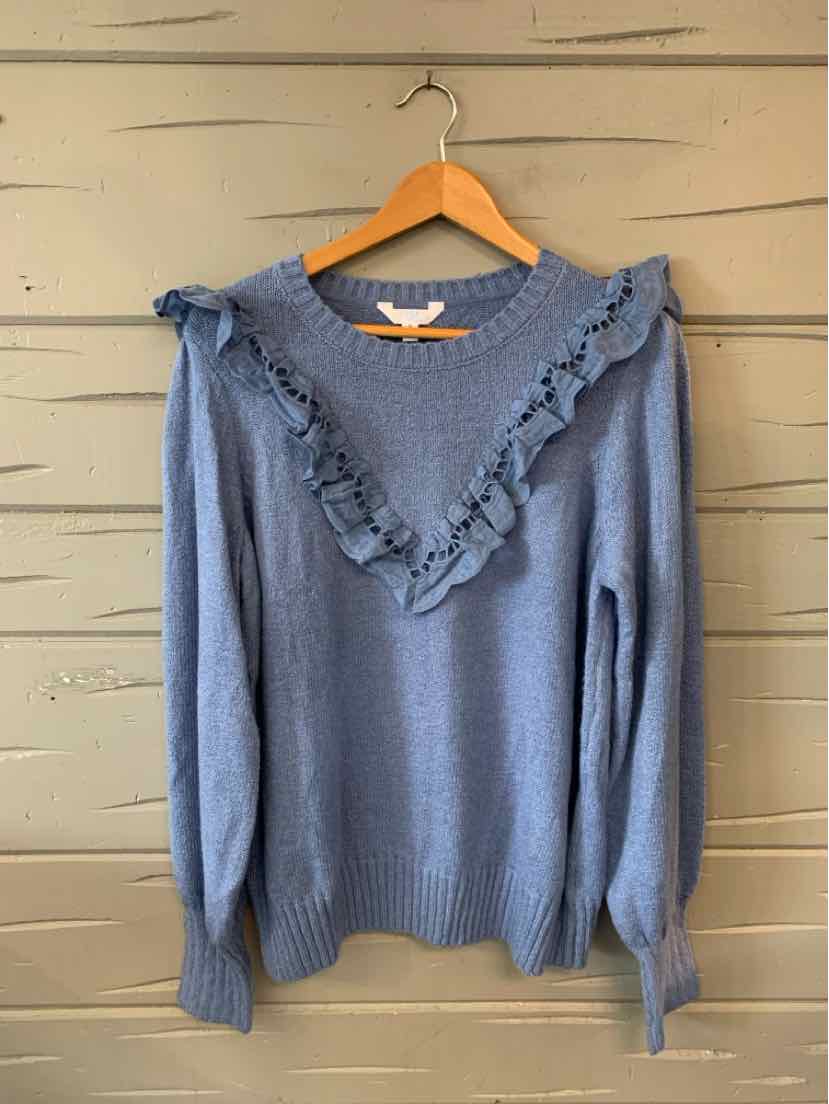 Blue long-sleeve knit sweater with ruffled V-shaped detail across chest and shoulders, ribbed cuffs and hem.