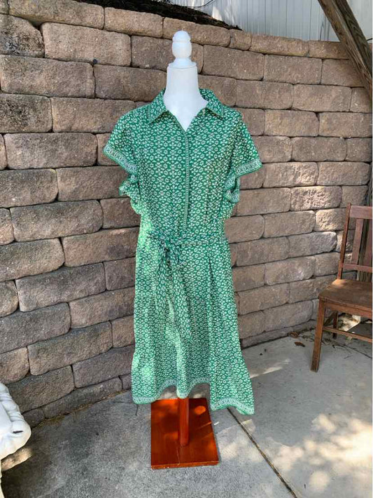 Green floral short-sleeve midi dress with collar and waist tie on mannequin outdoors.