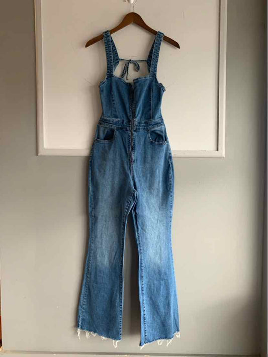 Blue denim overalls with adjustable straps, front chest pocket, and wide-leg cut with frayed hems.
