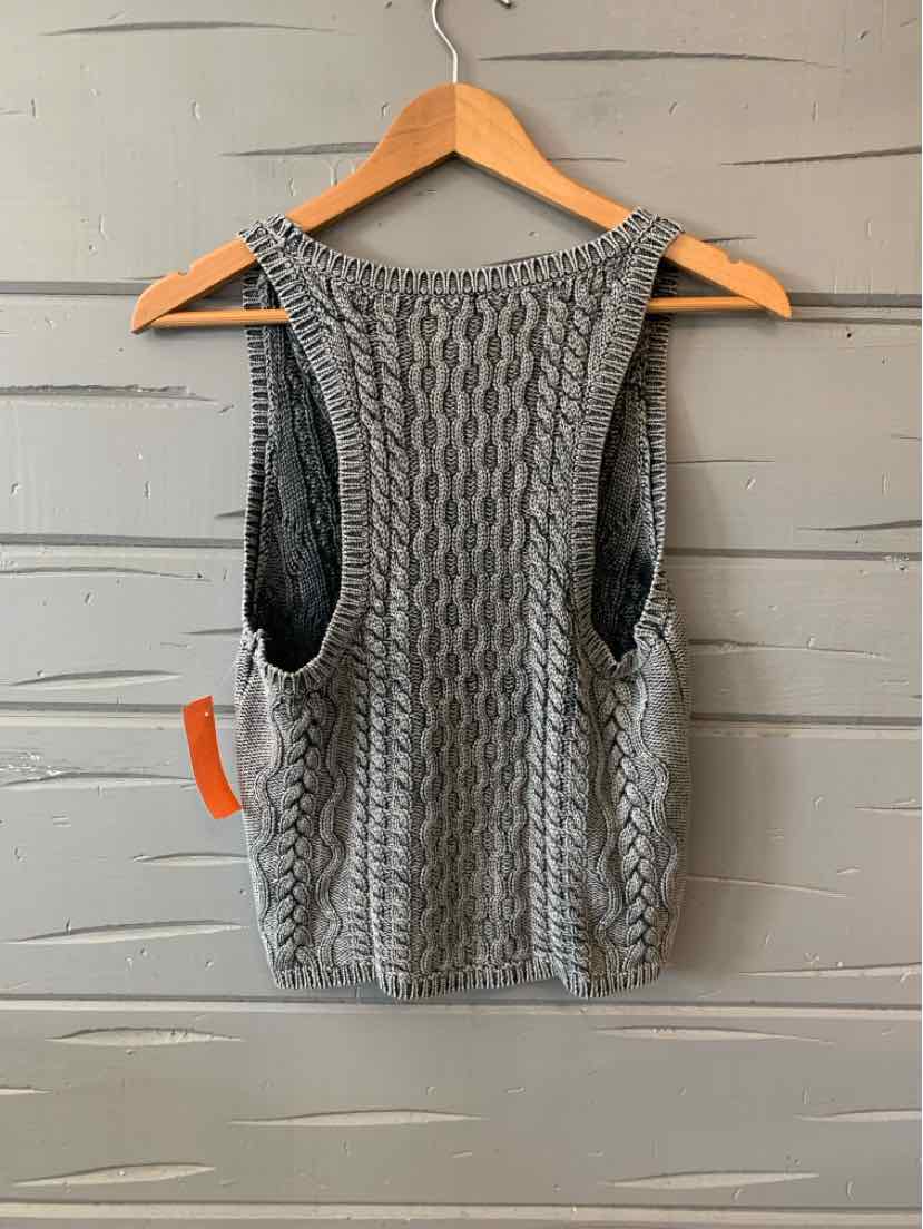 Gray knit sleeveless sweater vest with cable pattern and scoop neckline on wooden hanger.