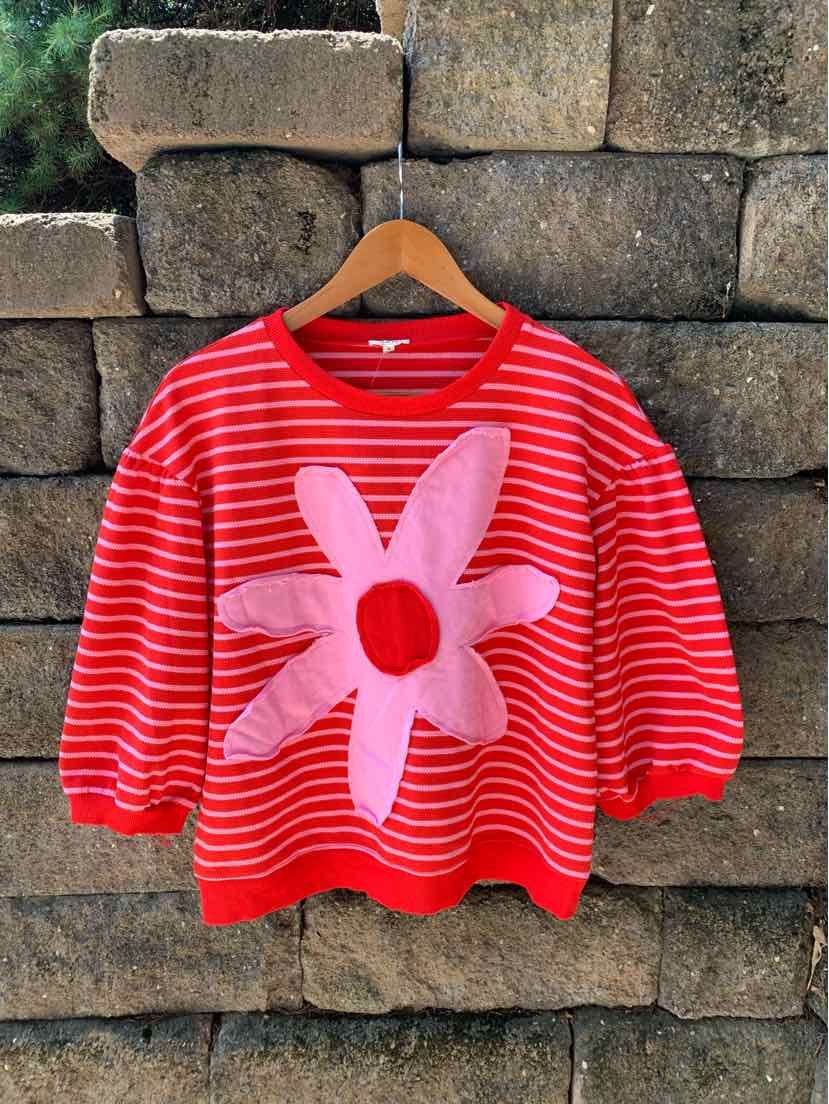 Red and white striped knit sweater with a large pink and red flower graphic on front, long sleeves, and ribbed cuffs and hem.