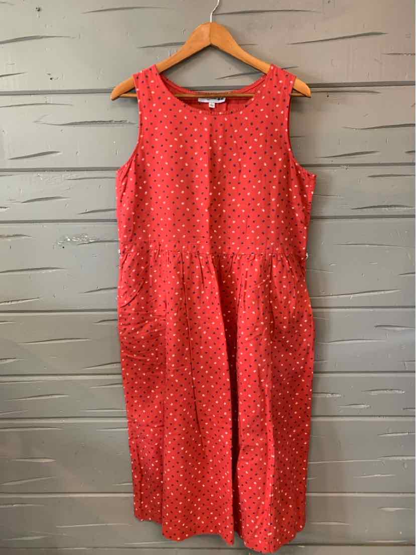 Sleeveless red midi dress with subtle floral print and round neckline, made from lightweight fabric.