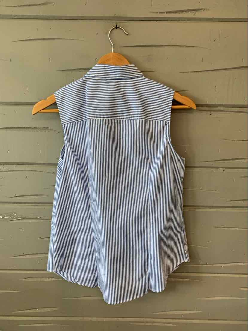 Sleeveless light blue and white pinstripe blouse with collared neck and curved hem hanging on wooden hanger against wooden.