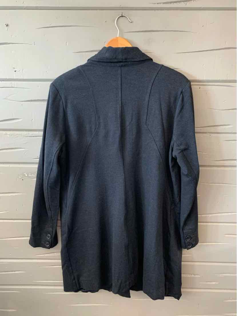 Long dark gray blazer with structured shoulders and tailored fit hanging on wooden hanger.