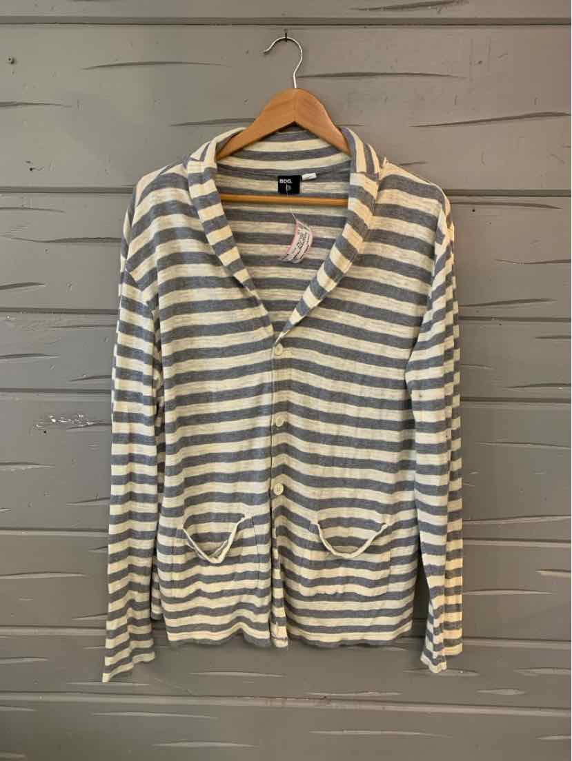Light gray and white striped cardigan with front pockets and button closure on wooden hanger.