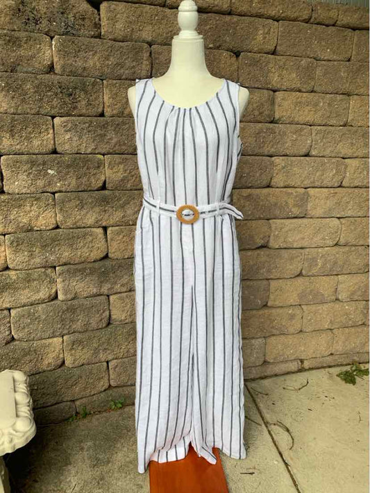 White sleeveless midi dress with vertical black stripes and a belted waist featuring a round buckle.