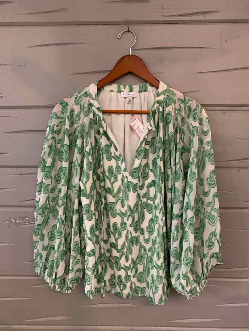 Lightweight white blouse with green abstract floral print and billowy long sleeves.
