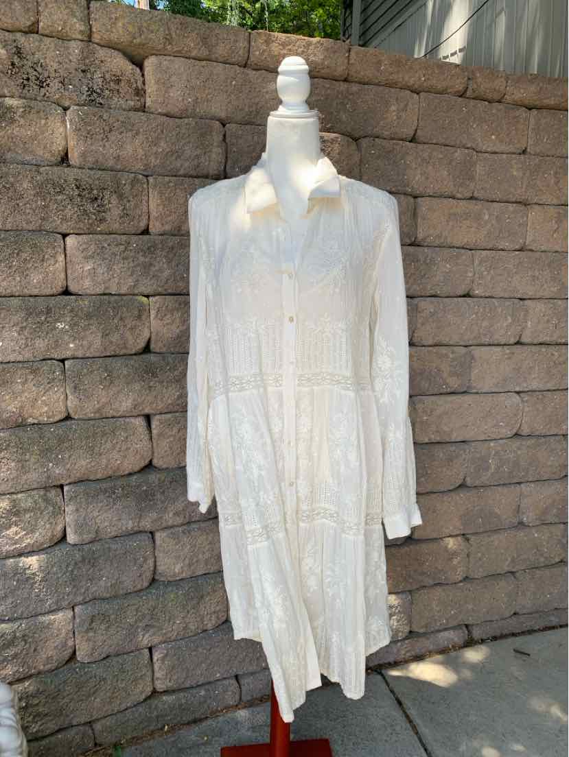 White long-sleeve button-down dress with collar and tiered skirt on mannequin.