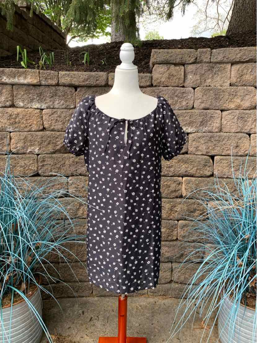 Black short-sleeve dress with white floral print, square neckline, and keyhole detail at front.