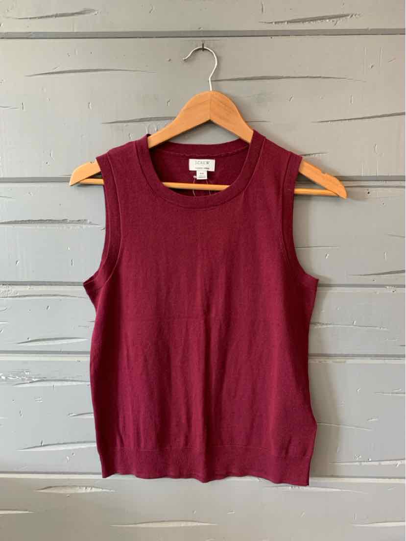 Sleeveless burgundy knit top with round neckline, slim fit, size XS, hanging on wooden hanger.