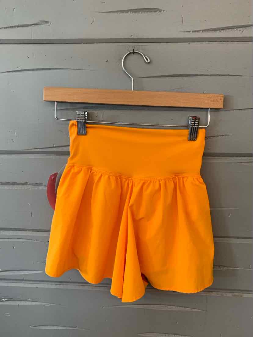 Bright orange high-waisted shorts with a wide elastic waistband and a loose, flared leg design.