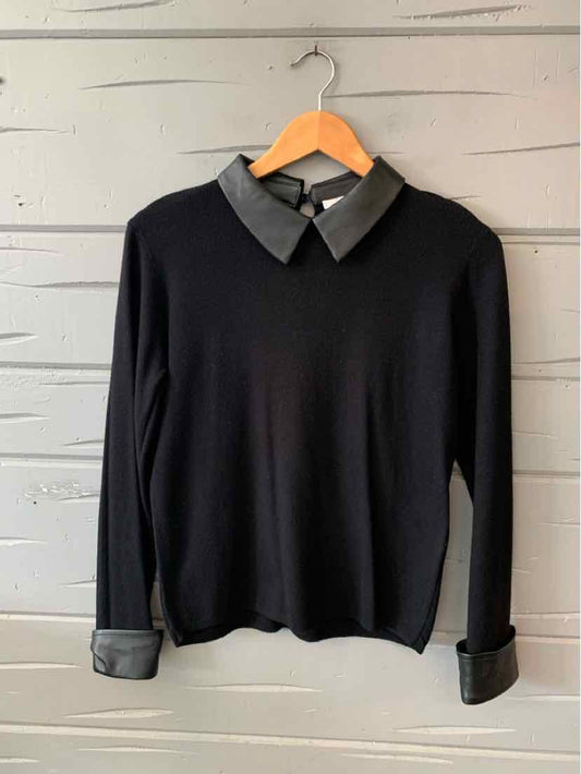 Black long-sleeve sweater with grey collar and grey cuffs on ribbed knit fabric.