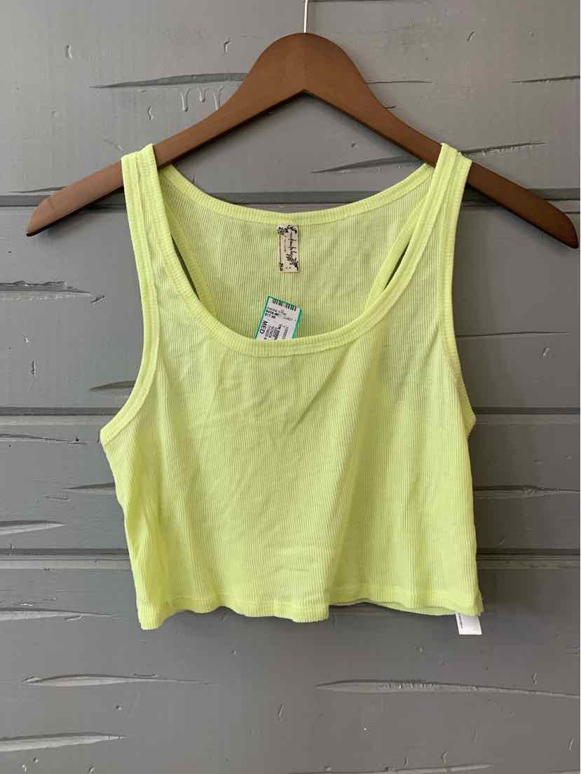Light yellow cropped tank top with scoop neckline and wide shoulder straps on wooden hanger.