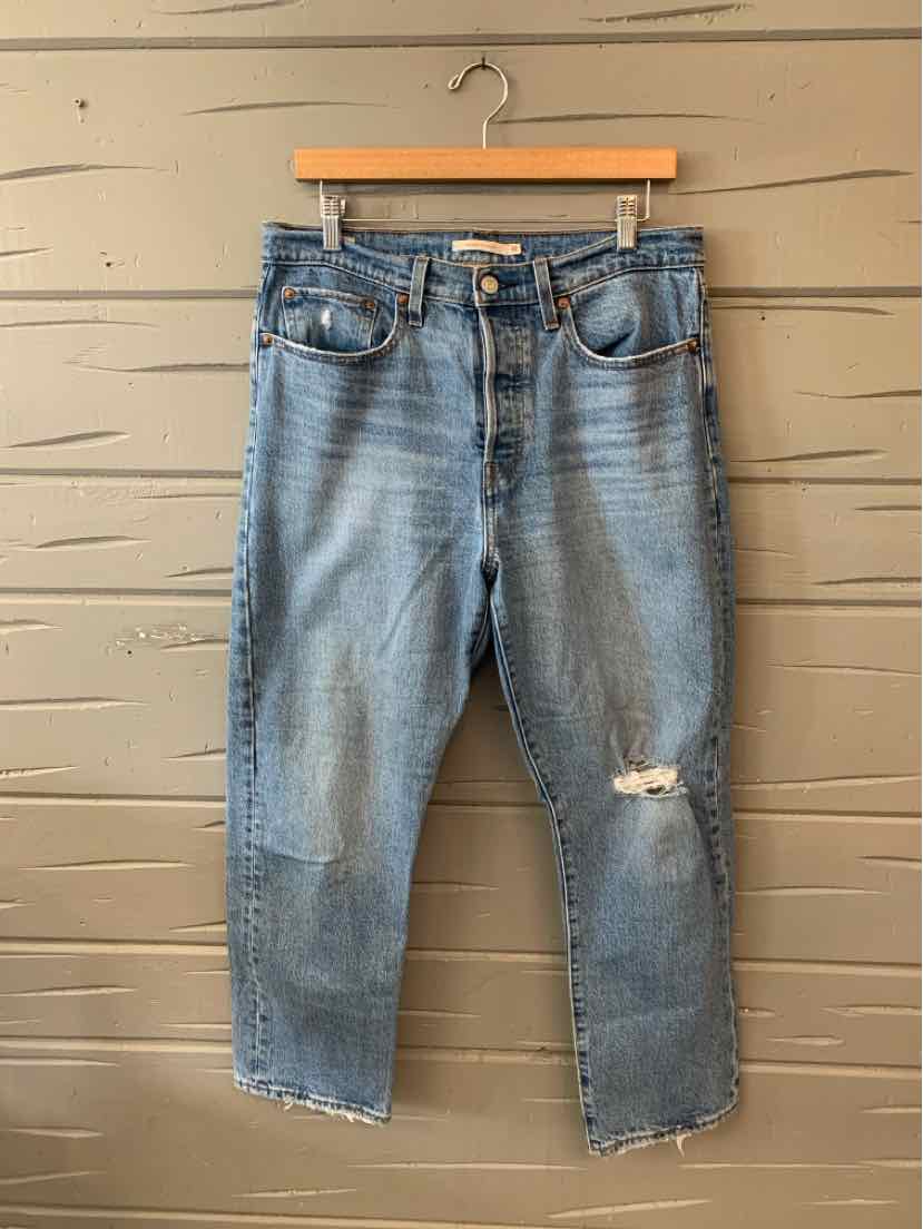 Light blue distressed Levi's denim jeans in size 10 with a relaxed fit and frayed knee detail.